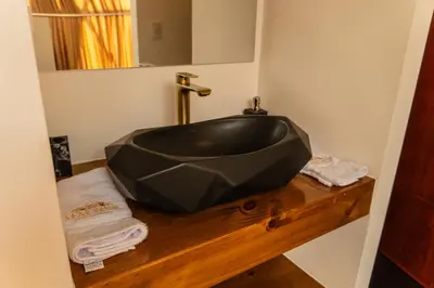 a black bath tub sitting on a wooden counter in a bathroom at Memorable Sacred Experience in Cusco