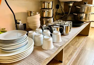 a table with white plates and dishes on it at Colina Haus, cabaña familiar Oxa in Oxapampa