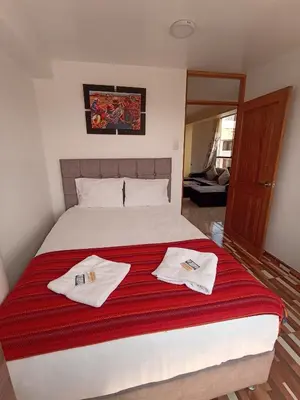 a bedroom with a bed with two towels on it at Templo Home in Cusco