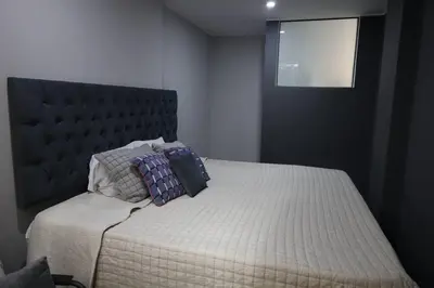 a bed with two pillows on it in a bedroom at Casa sabina aeropuerto entera in Lima