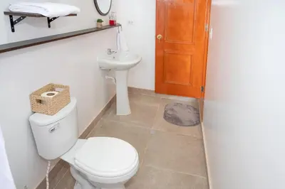 a bathroom with a toilet and a sink at Vive Chinchero in Ayarmaca