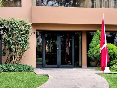 two red flags in front of a building at FlatTOP San Isidro City View Lima 3B 1804 in Lima