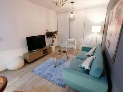 a living room with a blue couch and a tv at Barranco-Miraflores, ubicación A1, hermosa vista in Lima