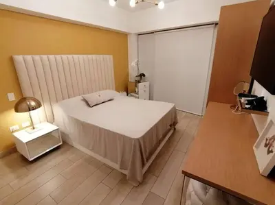 a small bedroom with a bed and a table at Barranco-Miraflores, ubicación A1, hermosa vista in Lima