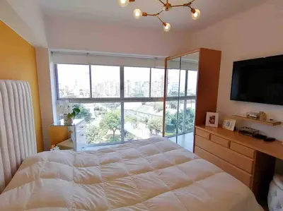 a bedroom with a large bed and a large window at Barranco-Miraflores, ubicación A1, hermosa vista in Lima