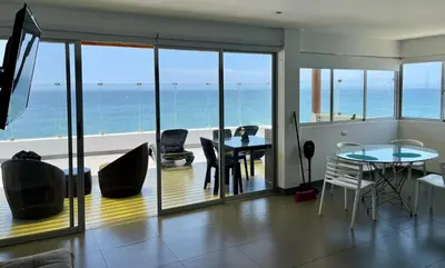 a living room with a view of the ocean at Suite 1ra Fila Vista Bahía Paracas - Sotavento 601 T3 in Paracas