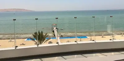 a view of the beach and the ocean from a building at Suite 1ra Fila Vista Bahía Paracas - Sotavento 601 T3 in Paracas