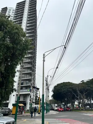 a tall building on the side of a street at San Isidro, lindo depa , 2tv wifi, piscina, lavanderia in Lima
