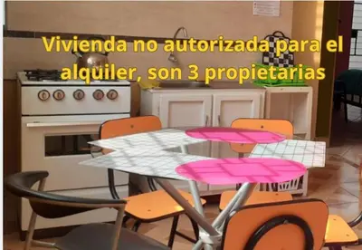 a kitchen with a table with pink chairs and a stove at Hermanas Pimentel in Ica