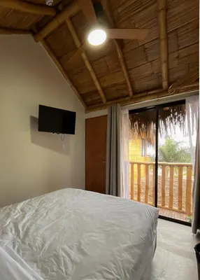 a bedroom with a bed and a flat screen tv at Narea San Bartolo in San Bartolo