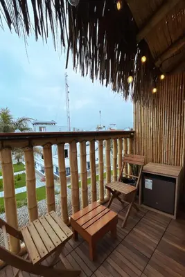 a porch with two chairs and a table and a stove at Narea San Bartolo in San Bartolo