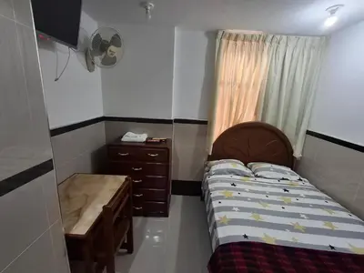 a small bedroom with a bed and a dresser at HOSPEDAJE JOVITa in Lima