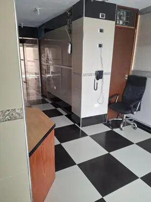 a office with a desk and a chair on a checkered floor at HOSPEDAJE JOVITa in Lima