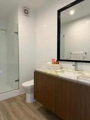 a bathroom with a sink and a toilet and a mirror at Departamento de lujo Miraflores con Aire Acondicionado in Lima