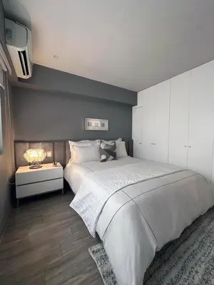 a bedroom with a large white bed and a tv at Departamento de lujo Miraflores con Aire Acondicionado in Lima