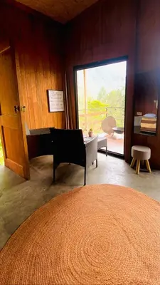 a room with a piano in a room with a window at Cabaña1 con hermosa vista al valle in Oxapampa