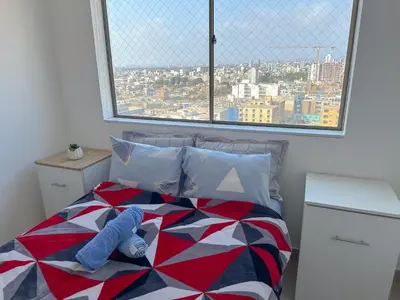 a bedroom with a bed with a large window at Apartamento exclusivo con terraza privada in Lima