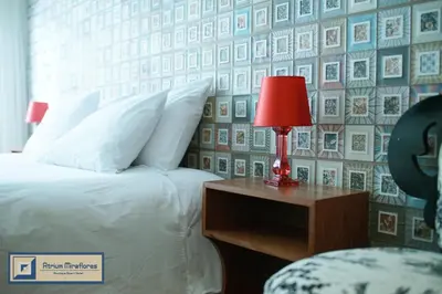 a bedroom with a bed and a red lamp on a night stand at Atrium Miraflores Hotel in Lima