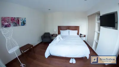 a bedroom with a bed and a flat screen tv at Atrium Miraflores Hotel in Lima