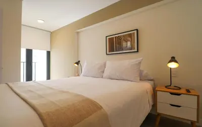 a bedroom with a bed and a lamp on a table at Artline in Barranco by Wynwood House in Lima