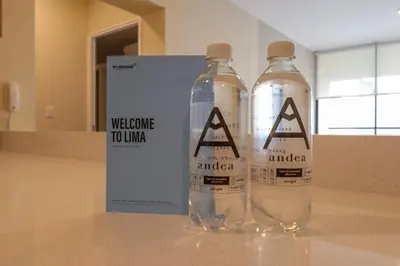 two water bottles on a counter with a welcome touador sign at Treehouse by Wynwood house in Lima