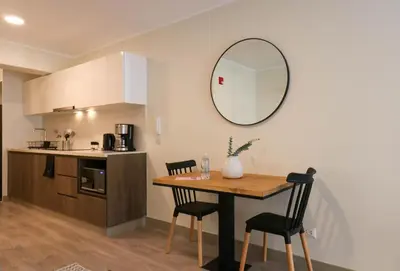 a kitchen with a table and a mirror on the wall at Studio 4 by Wynwood House in Lima