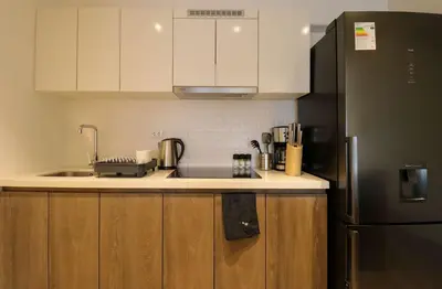 a kitchen with a sink and a refrigerator at Studio 4 by Wynwood House in Lima