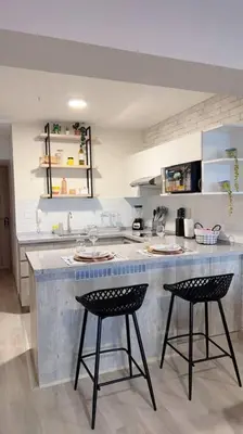 a kitchen with two bar stools and a counter top at Premium Loft-Moderno y Acogedor in Lima