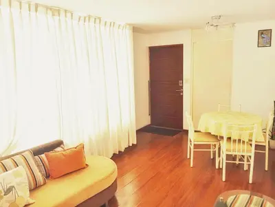 a living room with a couch and a table at Departamento Lima acogedor, ventilado, cálido y moderno San miguel, Lima, Perú in Lima