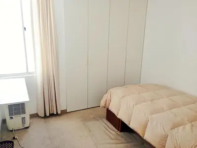 a bedroom with a bed next to a window at Departamento Lima acogedor, ventilado, cálido y moderno San miguel, Lima, Perú in Lima