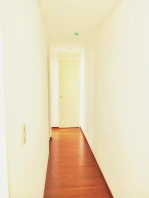 an empty hallway with white walls and a wooden floor at Departamento Lima acogedor, ventilado, cálido y moderno San miguel, Lima, Perú in Lima