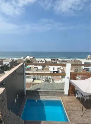 a view of the ocean from a balcony with a swimming pool at Ali Home in Punta Negra