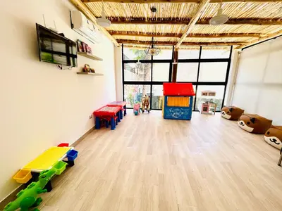 a room with a play room with toys and a table at Casa El Oasis de Ica in Ica