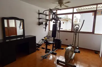 a room with a gym with exercise equipment and a mirror at Casa de 4 pisos cerca a embajada de USA y centros comerciales in Lima