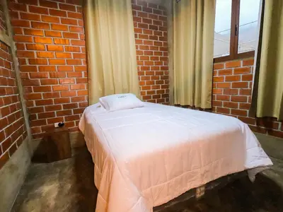 a bedroom with a bed in a brick wall at Taypu bungalow in Lunahuaná