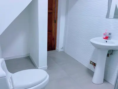 a white bathroom with a toilet and a sink at P2 Habitación Privada doble Miraflores, LIMA in Lima