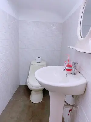 a white bathroom with a toilet and a sink at P2 Habitación Privada doble Miraflores, LIMA in Lima