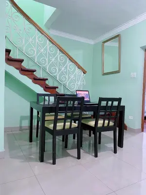 a dining room with a table and two chairs and a staircase at P2 Habitación Privada doble Miraflores, LIMA in Lima