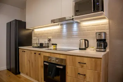 a kitchen with a sink and a microwave at Pendragon by Wynwood House in Lima