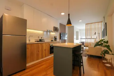 a kitchen with a stainless steel refrigerator and a counter at Pendragon by Wynwood House in Lima