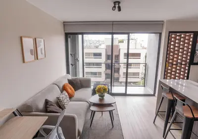 a living room with a couch and a table at Maravilla en barranco BR1 in Lima