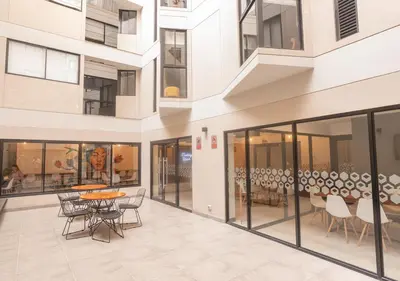 an empty mall with a table and chairs in a building at Maravilla en barranco BR1 in Lima
