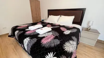 a bedroom with a bed with two towels on it at RANCH HAUS OXAPAMPA - PeT FRIENDLY in Oxapampa