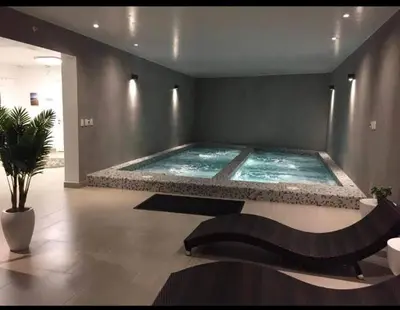 a large swimming pool in a large room at Departamento en PLAYA San Bartolo in San Bartolo
