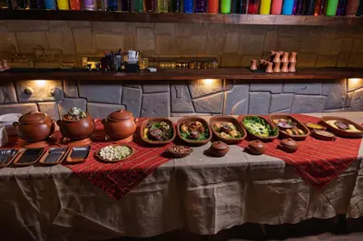 a table with many bowls of food on it at RUSTICA HOTELES CUSCO Urubamba in Pachar