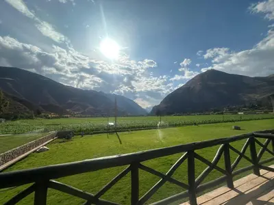 a view of a field with mountains in the background at RUSTICA HOTELES CUSCO Urubamba in Pachar