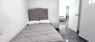 a bed with two pillows on it in a room at El Polo Surco in Lima