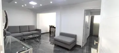a living room with a couch and a chair and a table at El Polo Surco in Lima