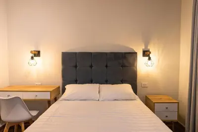 a bed with a black padded headboard in a room at Private room by the sea Miraflores in Lima