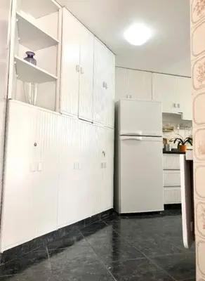 a kitchen with white cabinets and a refrigerator at Departamento jacuzzi Miraflores in Lima